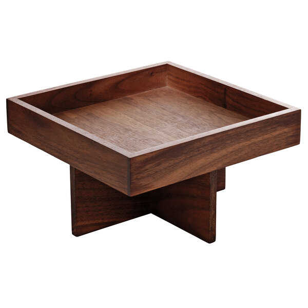 A walnut wood square tall tray on a square table.
