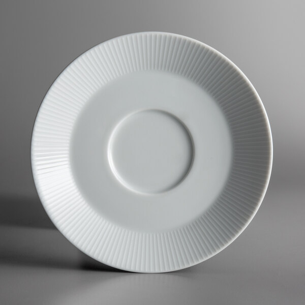 A Schonwald Continental white porcelain saucer with a circular pattern in the middle.
