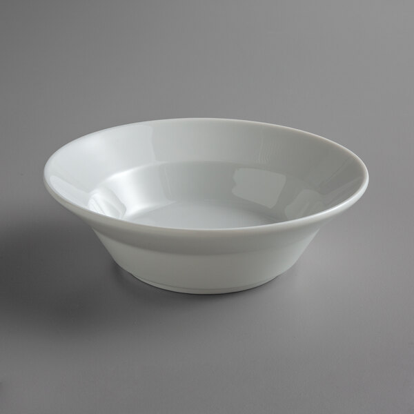 A close up of a Schonwald Continental White porcelain bowl on a gray surface.