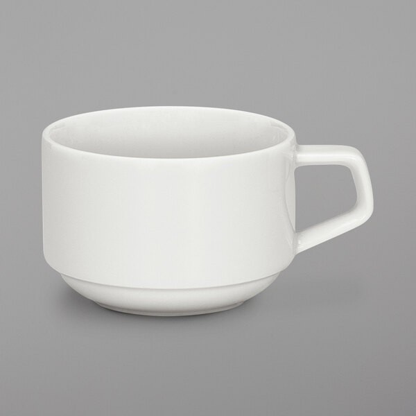 A Schonwald white porcelain cup with a handle on a white surface.