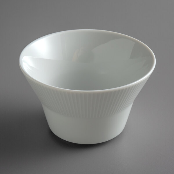 A Schonwald white porcelain bouillon bowl on a gray surface.