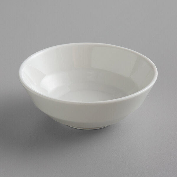 A close up of a Schonwald Allure bone white porcelain dip dish.