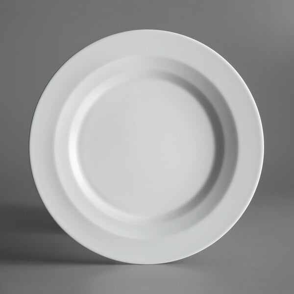 A Schonwald bone white porcelain plate with a white rim on a white background.
