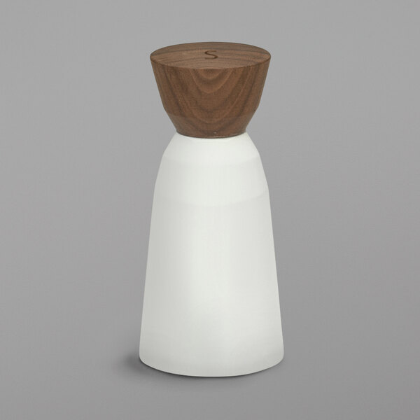A Schonwald bone white porcelain salt mill with a wood top and base.
