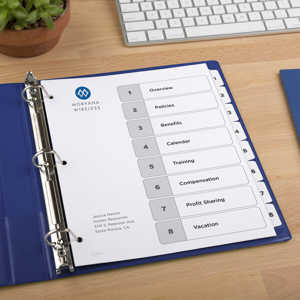 A blue binder with Avery white papers and a list of numbers on it.