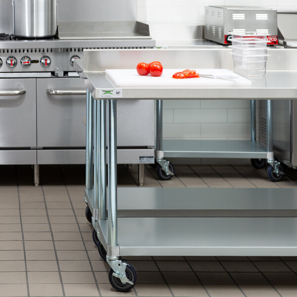 A stainless steel Regency commercial work table on wheels.