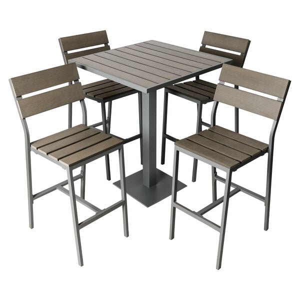 A BFM Seating Margate bar height outdoor table with four chairs on an outdoor patio.
