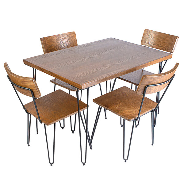 A BFM Seating table with wood veneer top and metal legs with four solid ash chairs.