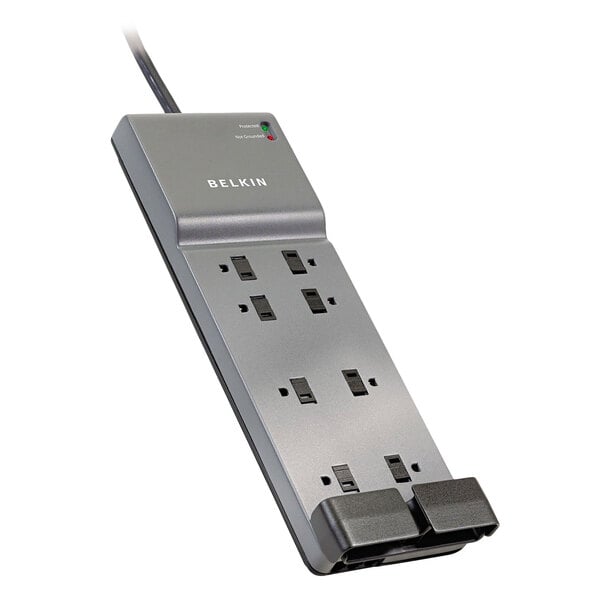 A close-up of a Belkin 8 outlet surge protector with two plugs in use.