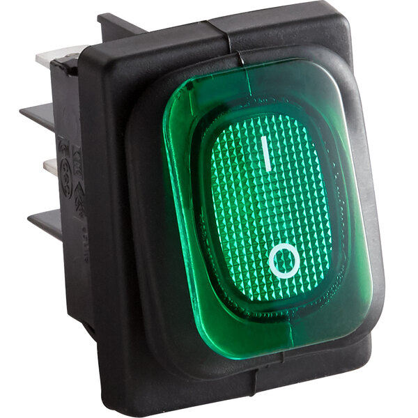 A green light on a black Avantco power switch.