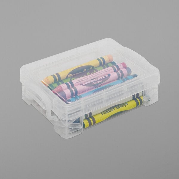 A clear plastic Advantus Super Stacker crayon box with yellow and green crayon wrappers inside.