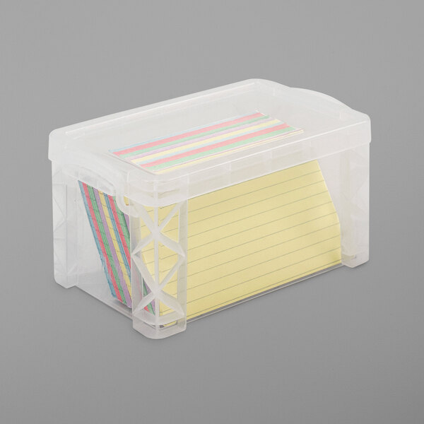 A clear plastic container with yellow lined paper inside.