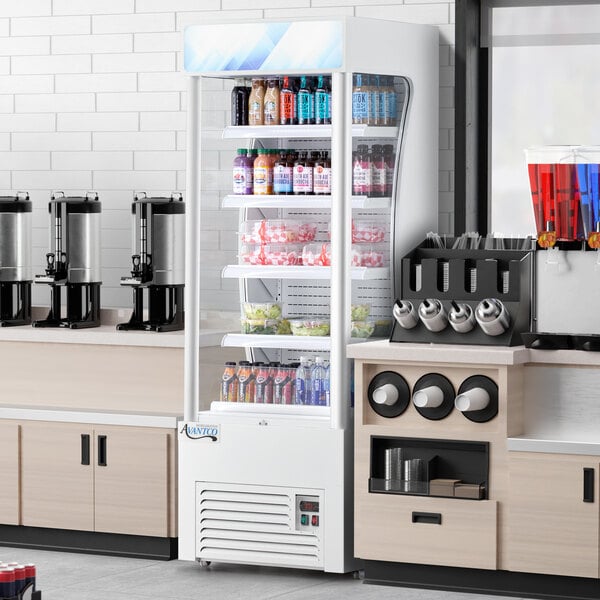An Avantco white refrigerated air curtain merchandiser with drinks and beverages.