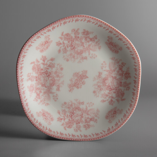 A pink porcelain Oneida Lancaster Garden plate with a floral design.