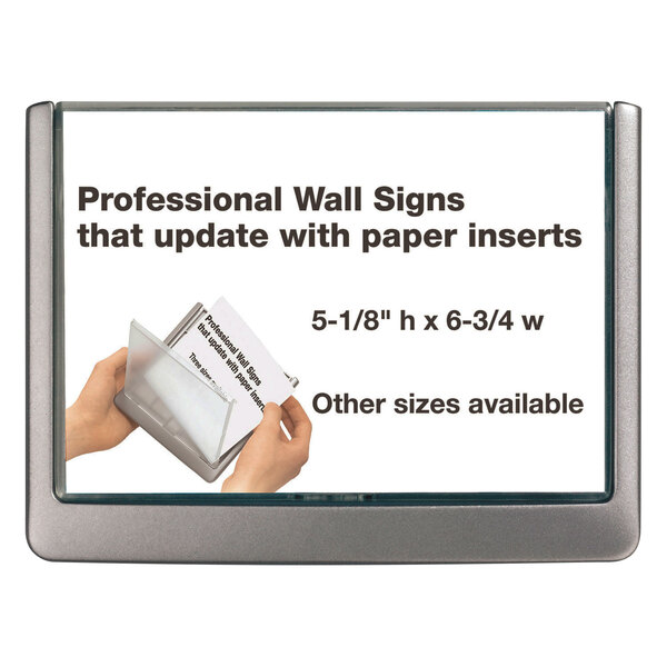 A hand inserting a paper into a Durable gray wall sign holder.
