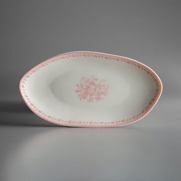 A white oval plate with pink floral design.