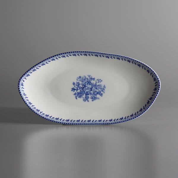 A white porcelain oval plate with a blue floral design.