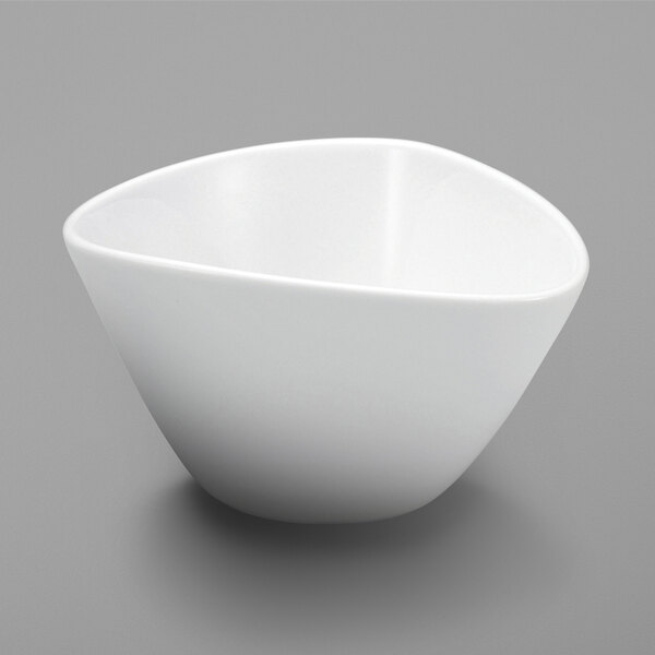 A close up of a Oneida Mood bright white porcelain rice bowl with a small hole in the middle.