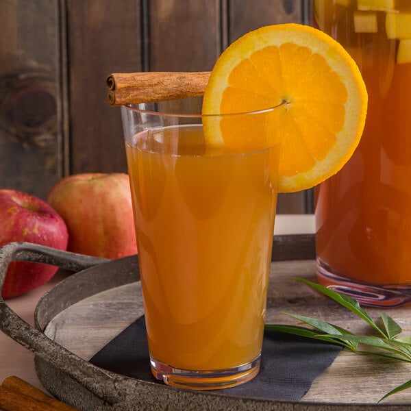 A slice of orange in a glass of Libbey orange juice.