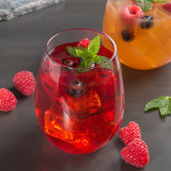 A Libbey Tritan plastic stemless wine glass filled with red liquid and ice with berries.