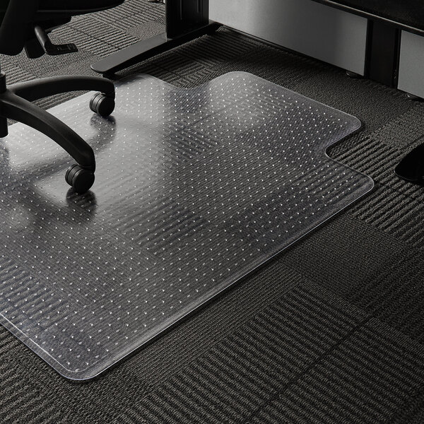 A close-up of an ES Robbins clear vinyl chair mat with a lip on a carpeted floor.