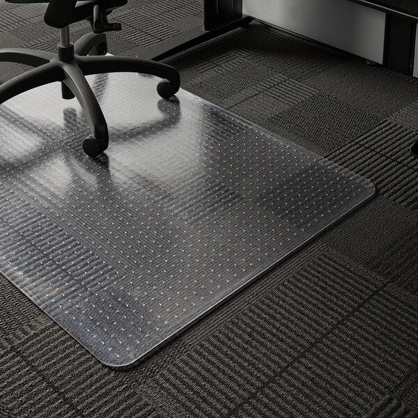 A black office chair with wheels on an ES Robbins clear vinyl chair mat.