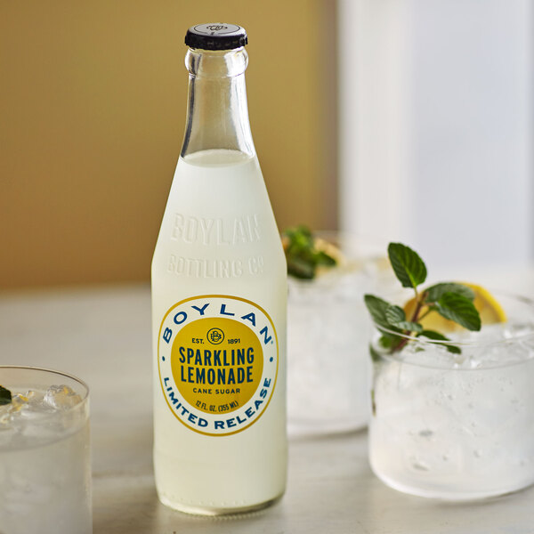 A white Boylan Bottling Co. lemonade bottle with a yellow label next to a glass of ice.