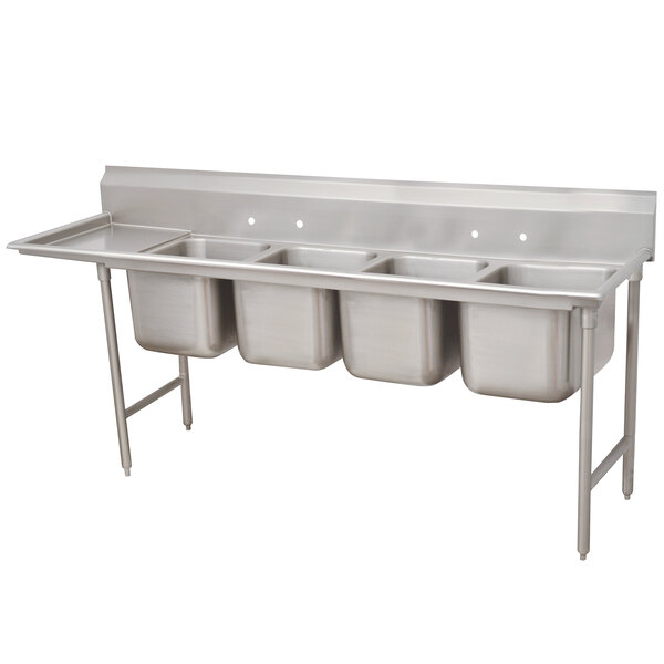 A stainless steel Advance Tabco four compartment pot sink with one drainboard on the left.