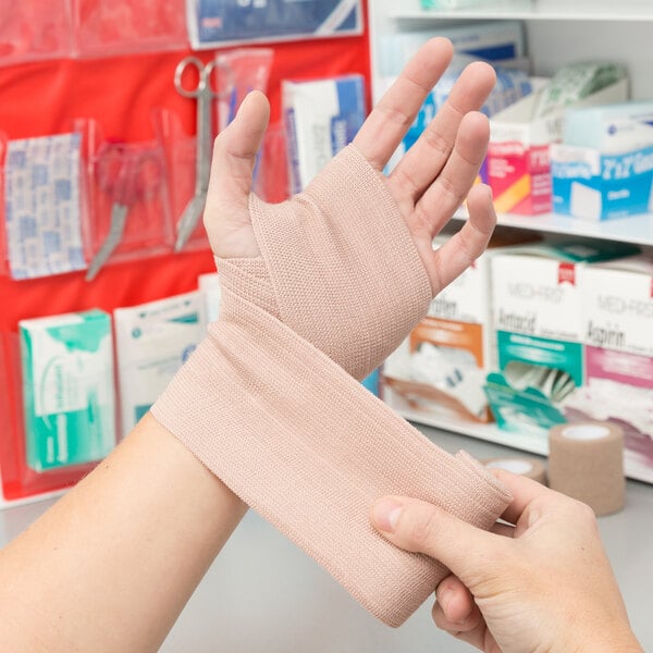 A hand wrapping with a Medi-First elastic bandage.