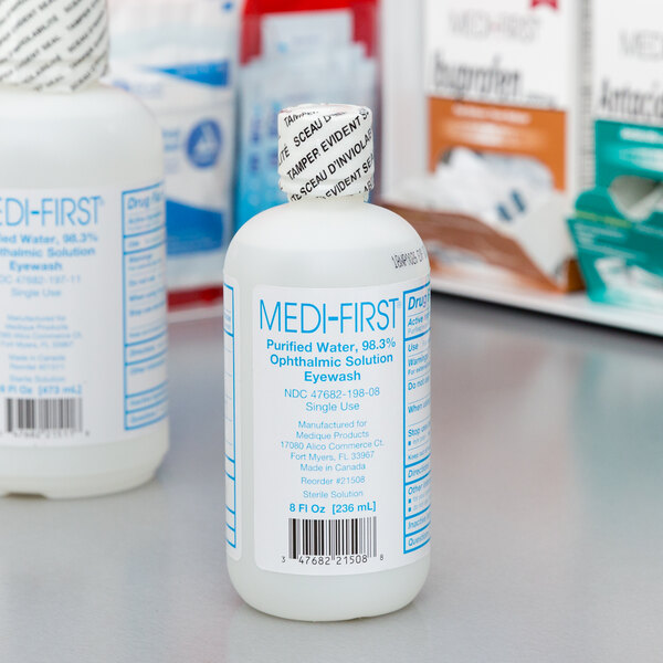 A white bottle of Medi-First Eye Wash with blue text.