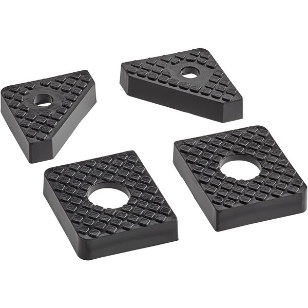 Four black rubber feet with holes in the middle.