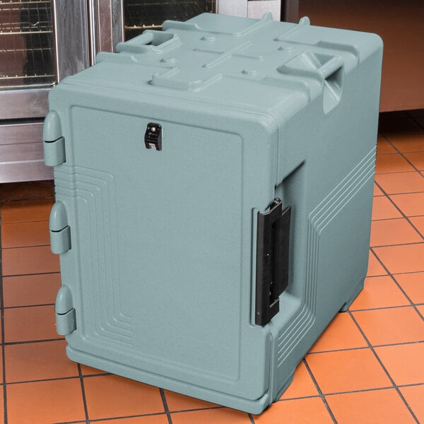 A grey plastic Cambro food pan carrier on a tile floor.