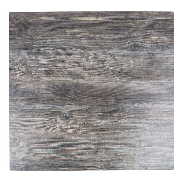 A BFM Seating Tribeca square driftwood composite laminate table top on a table outdoors.