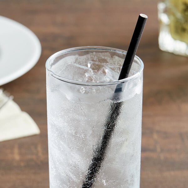 A glass of ice water with a black EcoChoice paper sip straw.