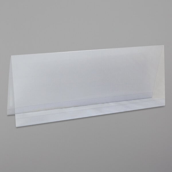 A clear plastic tent card holder on a white surface.