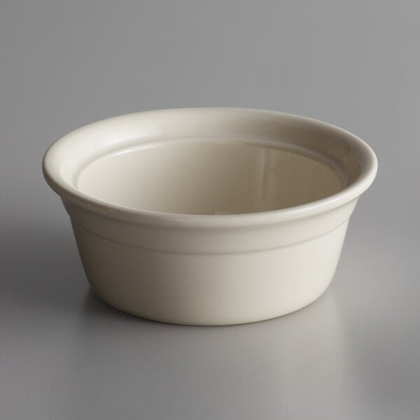 A Libbey Casablanca white porcelain casserole dish with a round rim on a gray surface.
