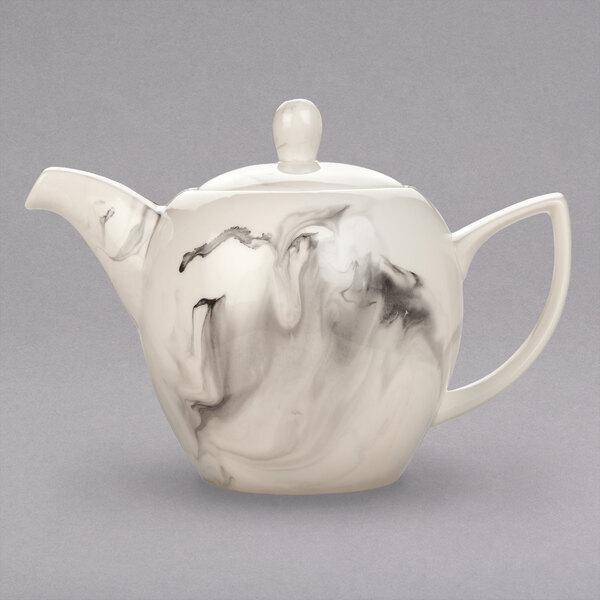 A white teapot with a black and white swirl design.