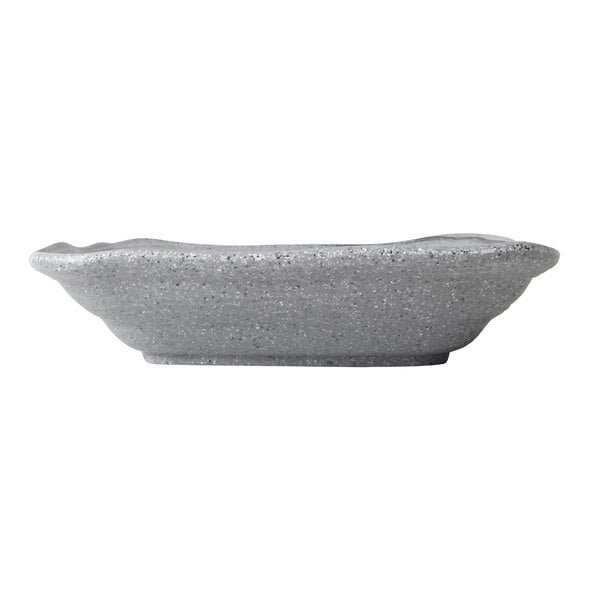A grey irregular square melamine bowl on a table.