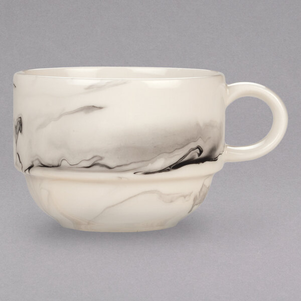 A white porcelain tea cup with black swirls.
