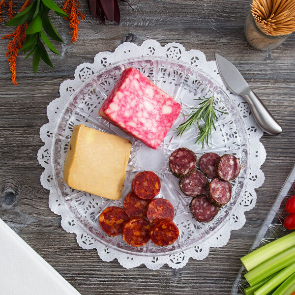 A Fineline crystal plastic catering platter with cheese, meat, and vegetables on it.