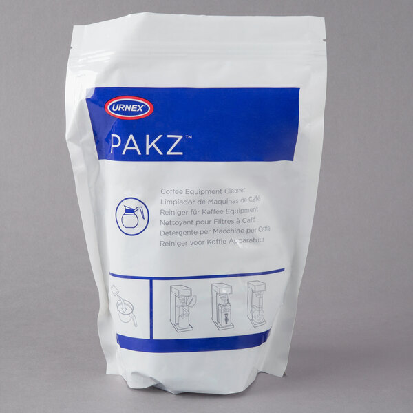 A white bag of Urnex Pakz coffee equipment cleaner packets with blue text.