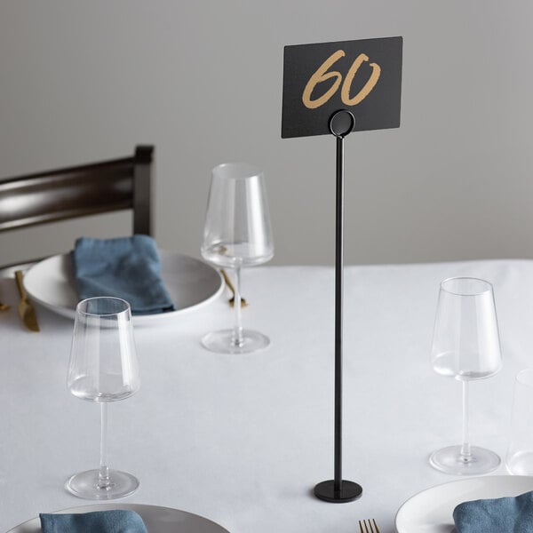 A table with a black Choice 18" menu holder with the number 60 on it.