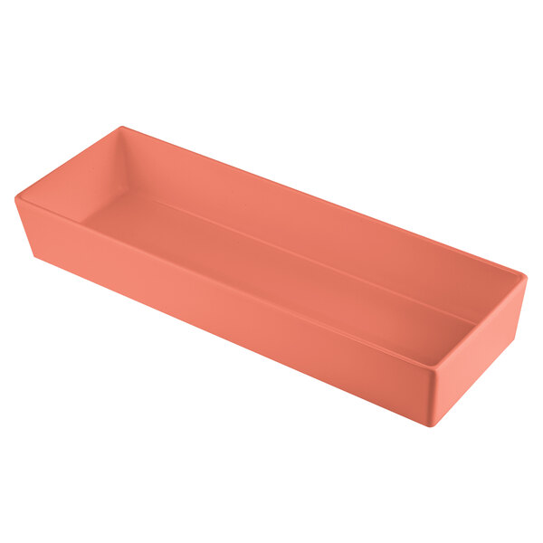 A Tablecraft Simple Solutions rectangular cast aluminum bowl in sunset orange on a table in a salad bar.