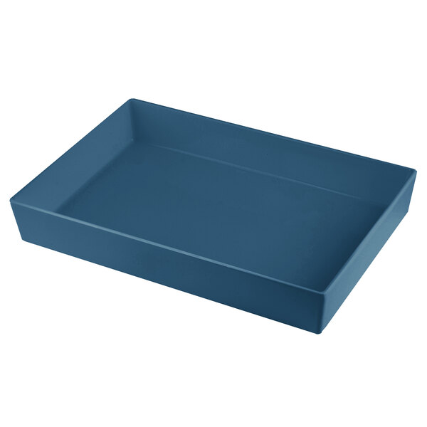 A blue rectangular cast aluminum bowl with straight sides on a counter in a salad bar.