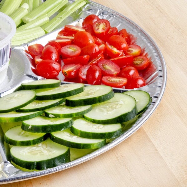 A 18" foil Lazy Susan tray with cucumber slices on it.