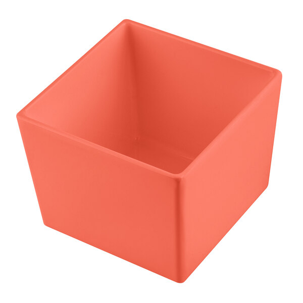A Tablecraft Simple Solutions 1/6 size sunset orange cast aluminum square container with straight sides.