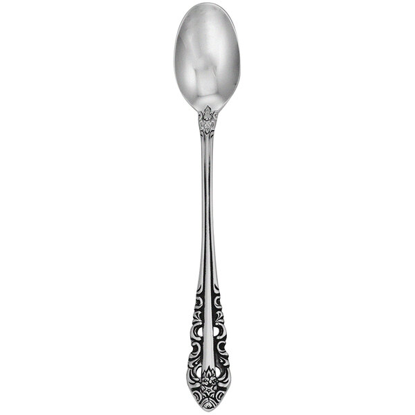A close-up of a Walco stainless steel iced tea spoon with an ornate design.