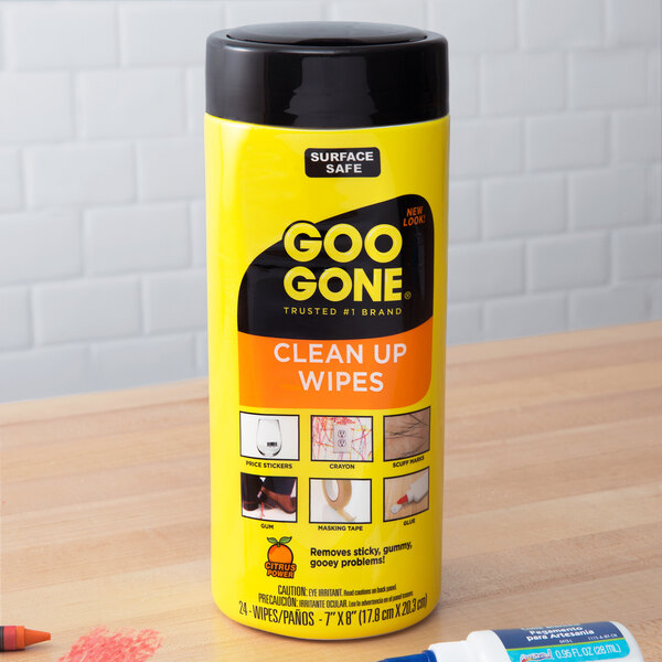 A yellow container of Goo Gone Clean Up Wipes with a black lid.
