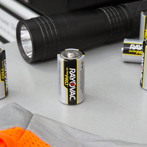 A group of Rayovac Ultra Pro C Alkaline batteries on a table.