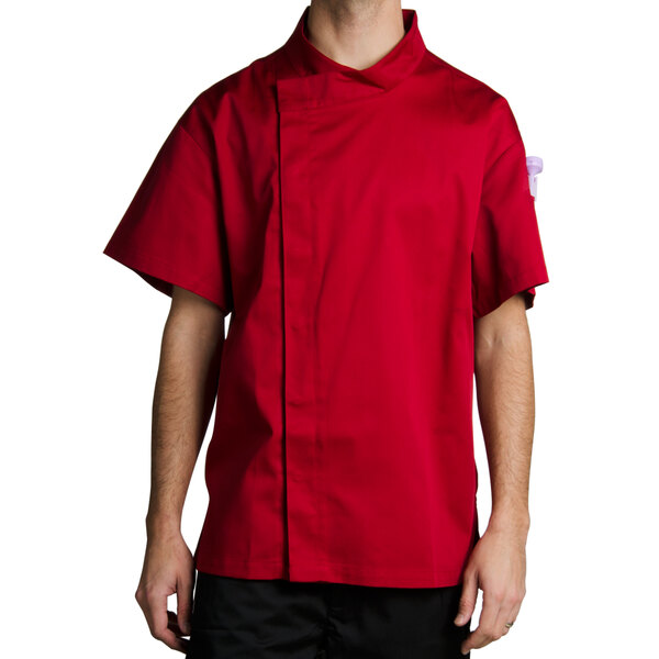 A man wearing a tomato red Chef Revival chef jacket with hidden snap buttons.